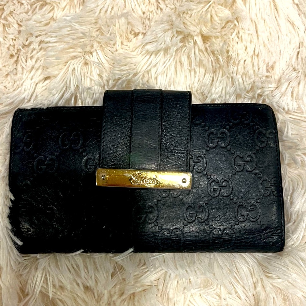 Authentic Gucci Guccisima black leather wallet with gold hardware.